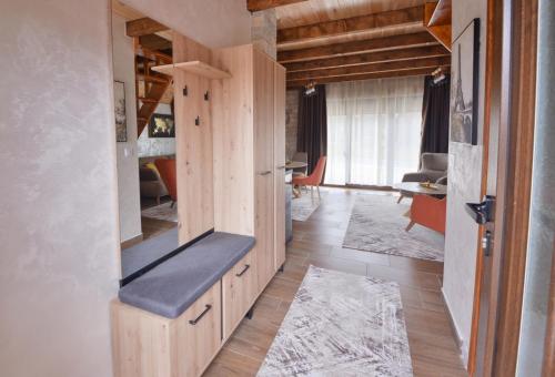 a room with wooden cabinets and a living room at Lux Villas Zabljak in Žabljak