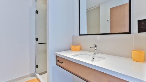 a bathroom with a sink and a mirror at Luxury StayCation - Tranquil Waters: 2BR Luxury Apart in Dubai Marina in Dubai