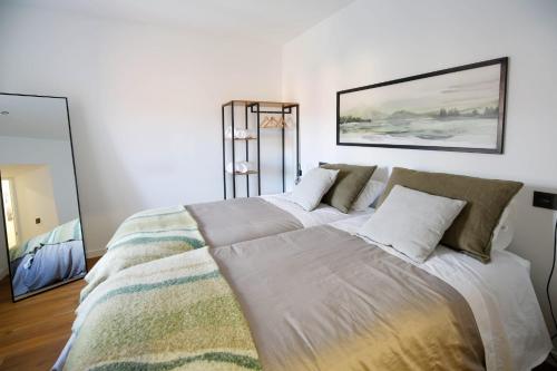 a bedroom with a large bed with pillows on it at La casa del patio in La Arboleda