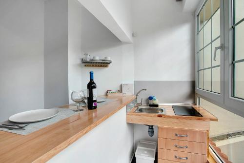 a kitchen with a sink and a bottle of wine on a counter at Duplex Carmelo y Carmela in Teror