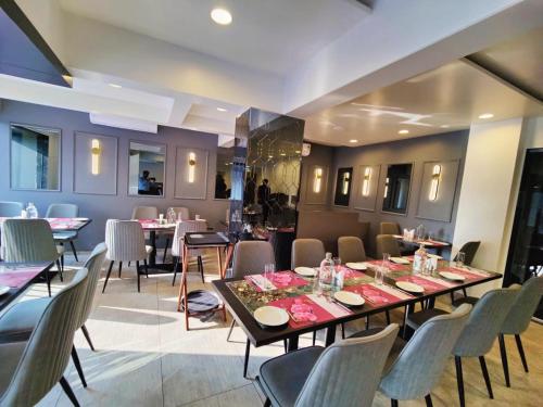 a dining room with a long table and chairs at Regenta Place Igatpuri in Igatpuri