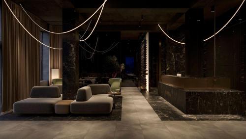 a lobby with a waiting area with chairs and a counter at Diamond Resort White in Bukovel