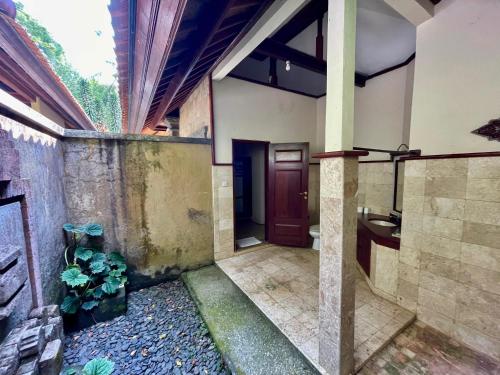 an outside view of a house with a bathroom at The Sangkih Villa Restaurant & Bar in Munduk
