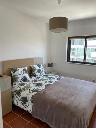 a bedroom with a bed and a window at Appartement, praia da rocha, PORTIMAO in Portimão