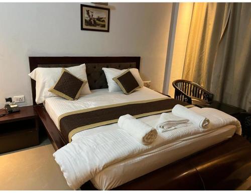 a hotel room with a bed with towels on it at Hotel lords,Dehradun in Dehradun