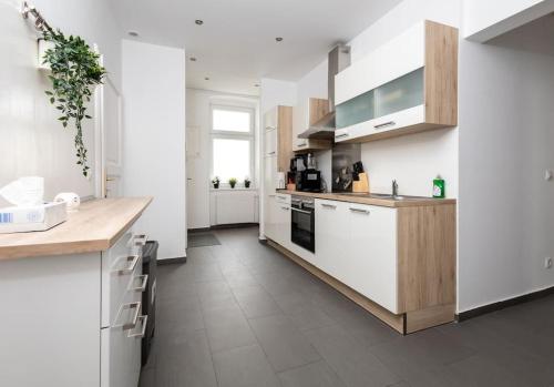 a kitchen with white appliances and a counter top at OrestaLiving - 2BR On the Danube Canal in Vienna