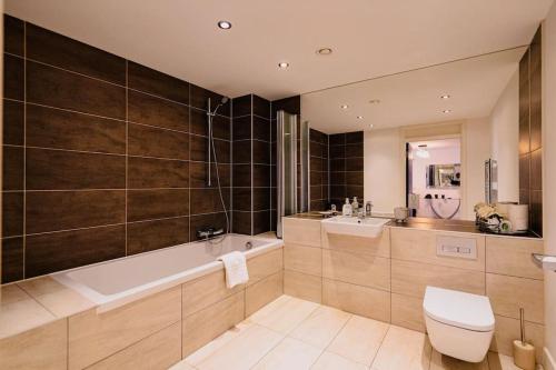y baño con bañera, aseo y lavamanos. en Marina with a view / 2 bd flat en Brighton & Hove