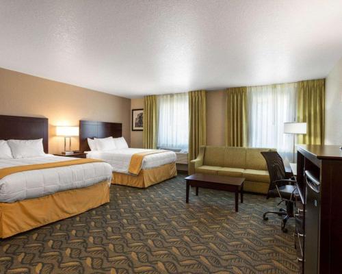 a hotel room with two beds and a couch at Quality Inn Prescott in Prescott