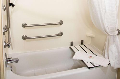 a bathroom with a toilet with two towel racks at Comfort Inn Sioux City South in Morningside