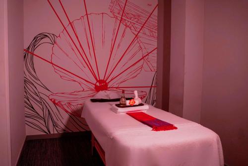 a room with a table with a chinese painting on the wall at Radisson RED Dubai Silicon Oasis in Dubai