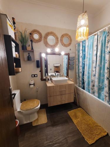 a bathroom with a toilet and a sink and a mirror at Immeuble walili in Fez