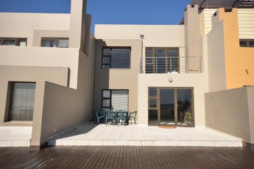 a view from the outside of a house with a patio at Ocean Dream Beach Cottage in Swakopmund