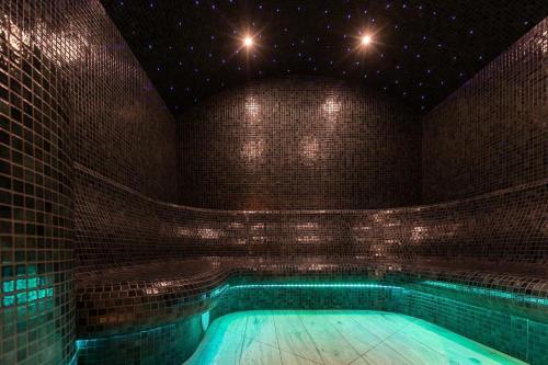 uma piscina num quarto com uma parede de tijolos em Hotel Fox em Wolbórz