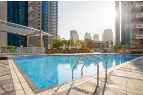 a large swimming pool on top of a building at Dubai Marina Apartment with Sea view, Pool and Gym in Dubai