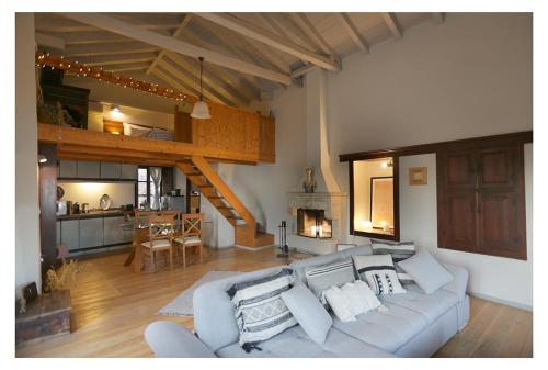 a living room with a couch and a kitchen at Daphne superior castle suite in Monemvasia