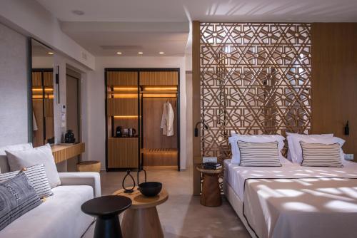 a bedroom with a large white bed and a couch at Niriides Palace in Gournes