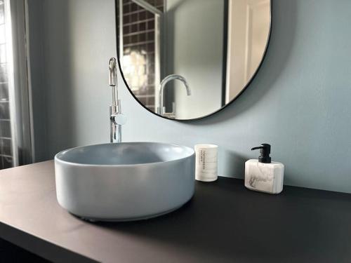 a bathroom with a bowl sink and a mirror at Maison Style & Espace à Angers in Angers