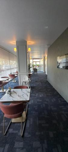 a hallway with tables and chairs in a building at My Rezidans Hotel in Manisa
