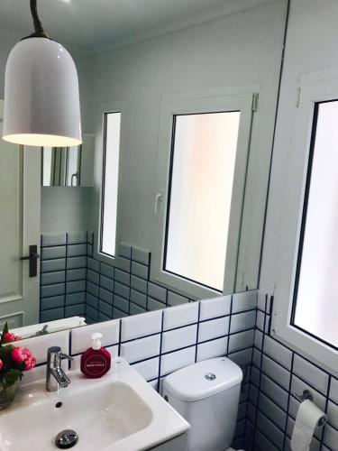a bathroom with a sink and a mirror and a toilet at Txobe Apartment in Elanchove