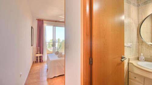a bathroom with a sink and a bathroom with a window at Residencial Playa Sol III in Denia