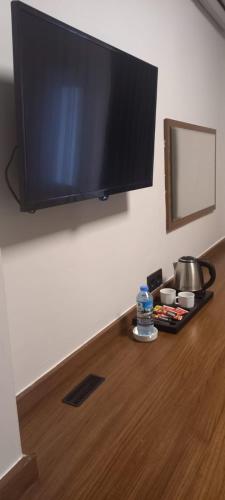 a flat screen tv hanging on a wall at My Rezidans Hotel in Manisa
