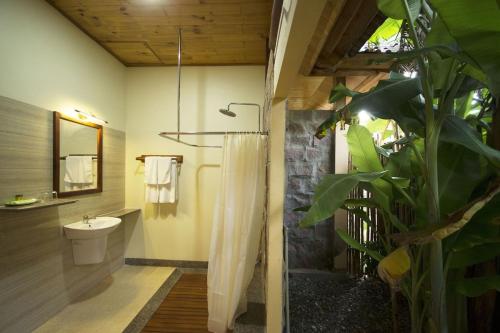 a bathroom with a shower with a sink and a toilet at Paradiso Phu Quoc Resort in Phu Quoc