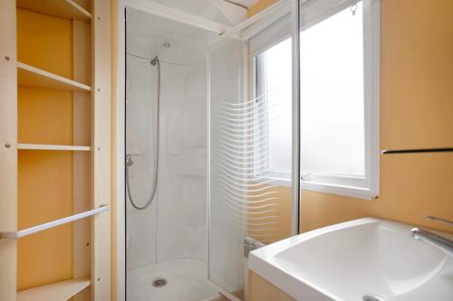 a bathroom with a shower and a white sink at Bungalow T2 V - 15 Min From Nazaré in Pataias