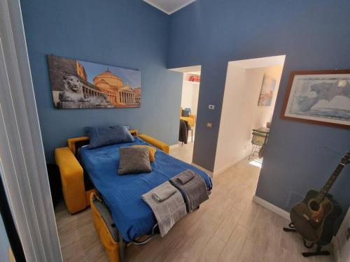 a bedroom with a bed with a blue wall at Pastel blue house x 5 people in Corso above metro Montesanto in Naples