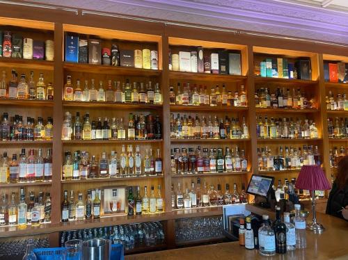 a room filled with lots of bottles of alcohol at Aberlour Apartment 92 B in Aberlour