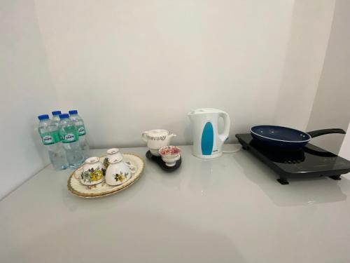 a table with a plate of food and bottles of water at Concetta Inn in Manolo Fortich
