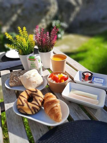 a table topped with plates of food and pastries at Formosa 178 by Guestify in Porto