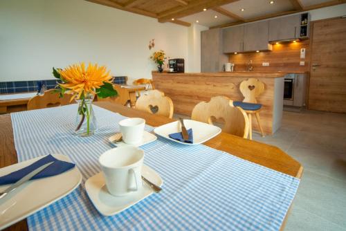 a dining room table with a blue and white table cloth at Panoramablick Heimen in Hopferau