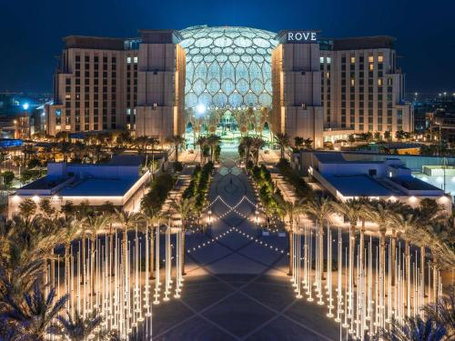 a view of the royal palm hotel at night at Rove Expo City in Dubai
