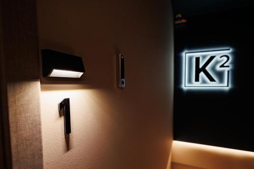 a bathroom with a sign on the wall at K2 Suites Kalamata in Kalamata