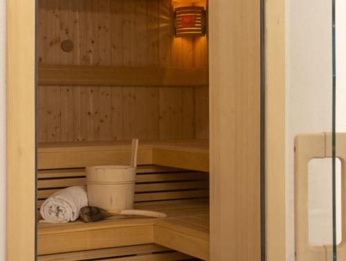 a dog laying in a sauna with a towel at Panoramablick Heimen in Hopferau