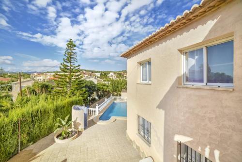 a house with a balcony with a swimming pool at Villa Sasha - PlusHolidays in Calpe