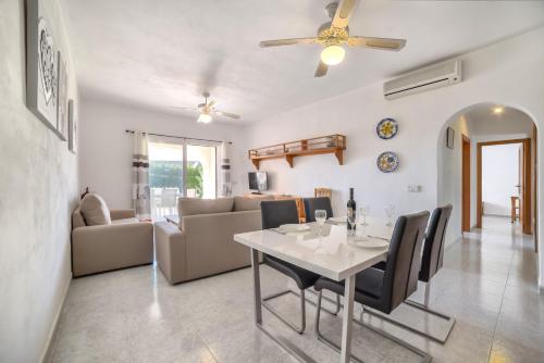 a dining room and living room with a table and chairs at Villa Sasha - PlusHolidays in Calpe