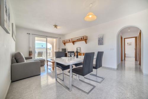 a dining room and living room with a table and chairs at Villa Sasha - PlusHolidays in Calpe