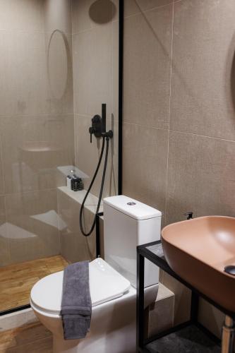 a bathroom with a toilet and a sink at K2 Suites Kalamata in Kalamata