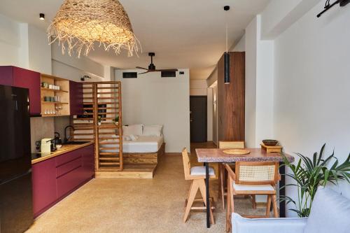 a kitchen and dining room with a table and a dining room at Mosaics Athens Boutique Apartments in Athens