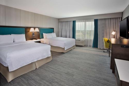 a hotel room with two beds and a television at Hampton Inn Union City, Tn in Union City