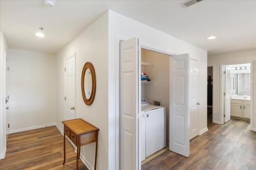 a room with white walls and a table and a mirror at Lake Front Condo with a Balcony! in Osage Beach