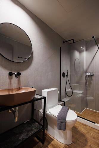 a bathroom with a sink and a toilet and a shower at K2 Suites Kalamata in Kalamata