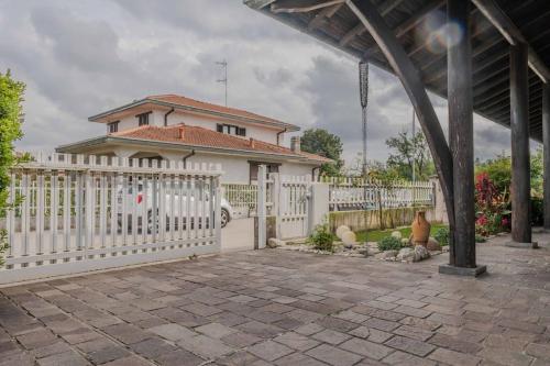 a white fence in front of a house at [Ca' Roby] Malpensa Airport relax - Free Wifi in Vizzola Ticino