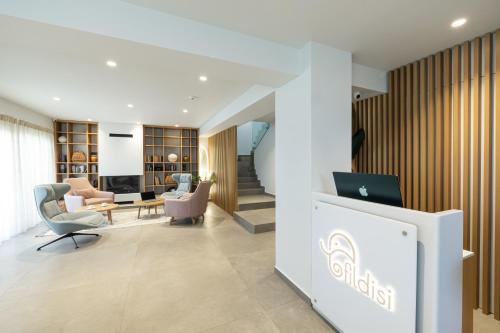 an office lobby with a desk and chairs at Fildisi luxury suites in Nafplio