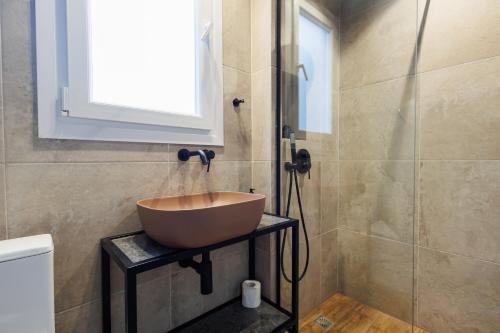 a bathroom with a bowl sink and a shower at K2 Suites Kalamata in Kalamata