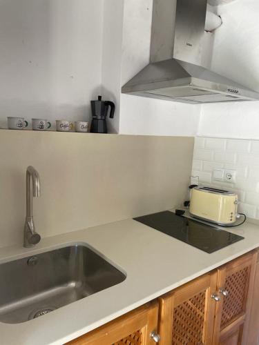 a kitchen with a sink and a toaster on a counter at Cortijo la Noria I in Puebla de Don Fadrique