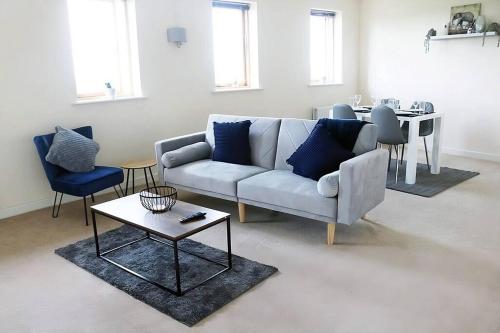 a living room with a couch and a table at Bright 2Bed Central Apartment in Milton Keynes
