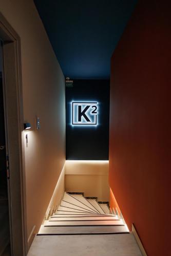 a room with a sign on the wall and stairs at K2 Suites Kalamata in Kalamata