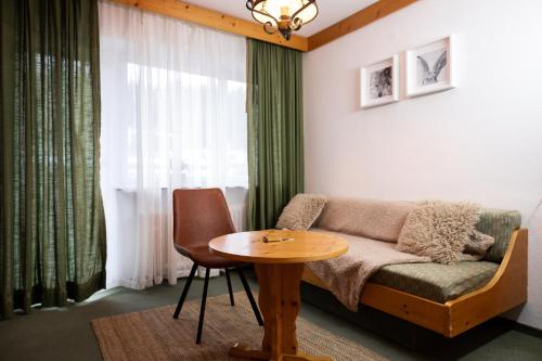 a living room with a couch and a table at Hotel zum See, Titisee in Titisee-Neustadt